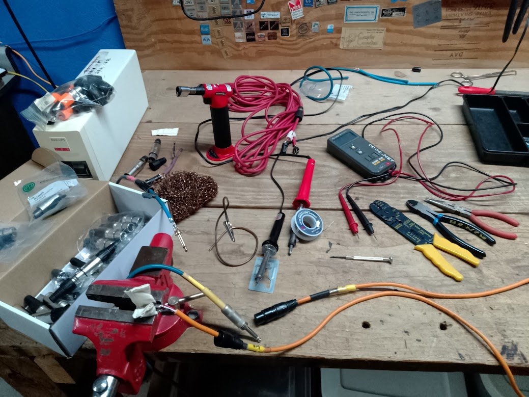 Cdoc soldering bench — torch, multimeter, fiber, crimpers