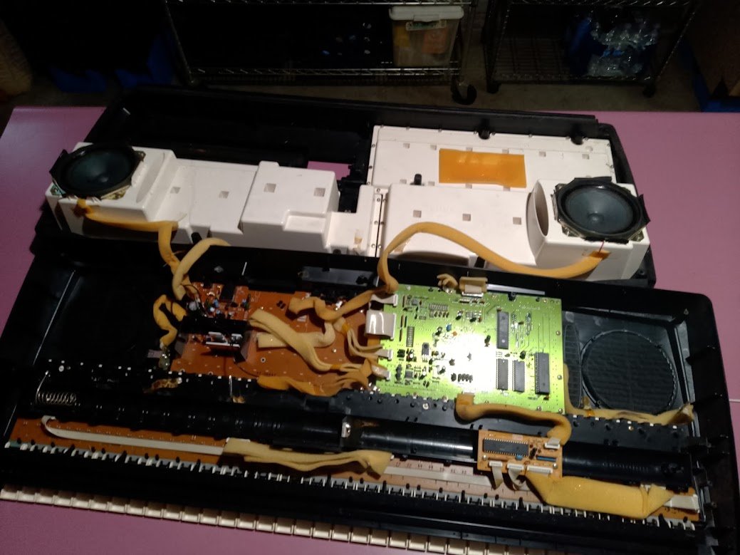 Yamaha keyboard internals close — ribbon cables and circuit board
