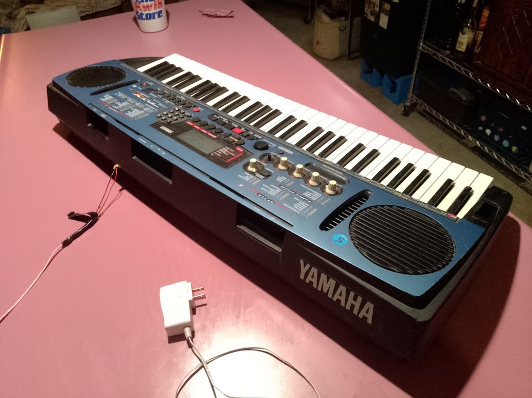 Yamaha keyboard intact on bench