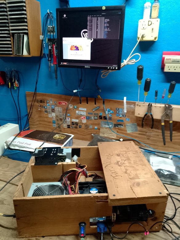 Speedy at the bench, first boot, Dell monitor, blue wall